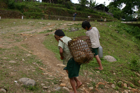 kid carrying heavy water